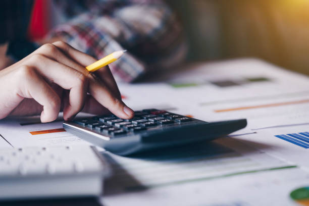 istock Businesswoman analyzing investment charts with calculator for financial data analyzing counting. Business financial analysis and strategy concept. 1131274890