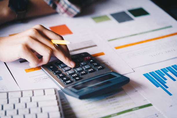 istock Businesswoman analyzing investment charts with calculator for financial data analyzing counting. Business financial analysis and strategy concept. 1131274921