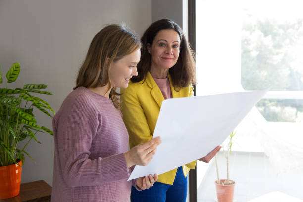 istock Architect showing house design drawing to client 1131277423