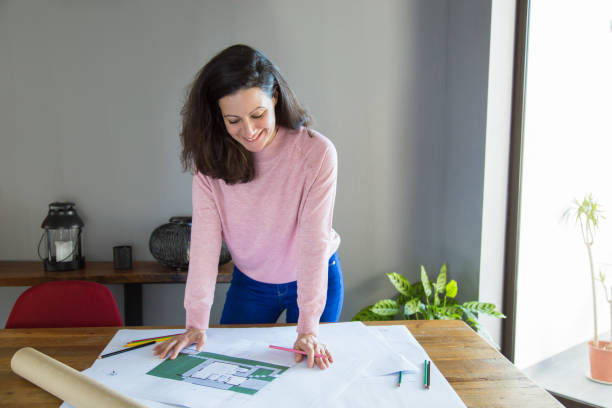 istock Positive successful apartment designer working with floor plan 1131277481