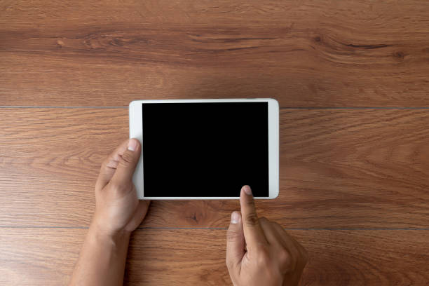 istock Man hand holding the black smartphone screen mockup 1131277644