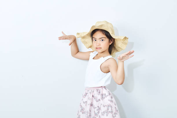 Pretty asian children wear a fashion hat.in Studio on a white background. Toning, Copy space, daylight