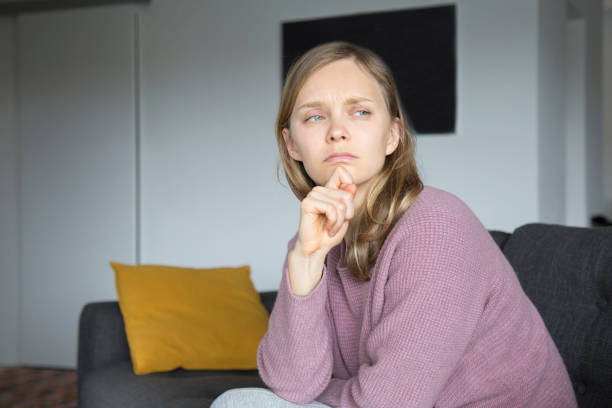 istock Upset young woman keeping fingers on lips 1131278629