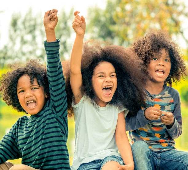 istock Happy kids group playing in the park in school. 1131282223