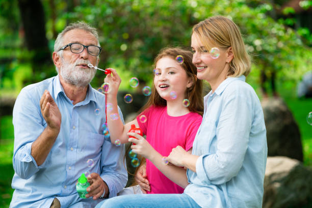 istock Happy family blowing soap bubbles in the park. 1131283269