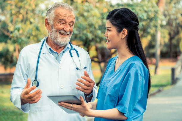 istock Senior and young doctor working in the park. 1131283306