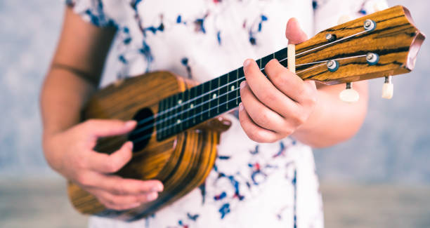 istock Happy woman musician playing ukulele in studio. 1131285154