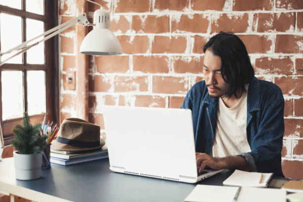 istock Young Asian man working on laptop for business creative designer 1131285306