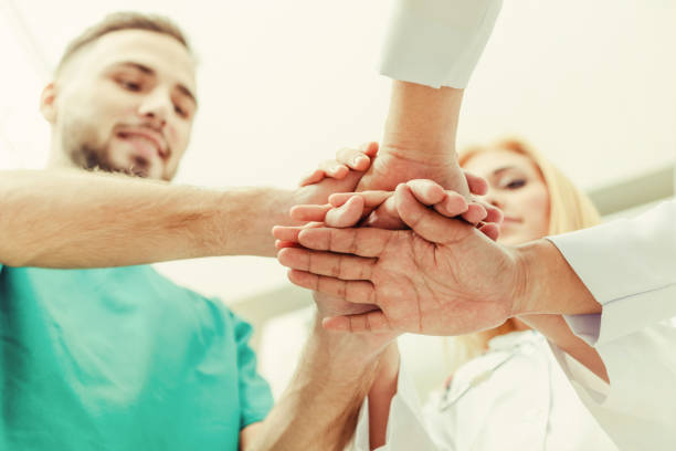 istock Doctor, surgeon and nurse join hands together. 1131286871