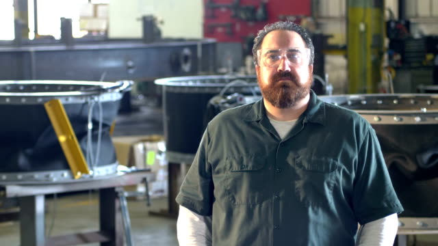 Man with beard working in metal fabrication shop