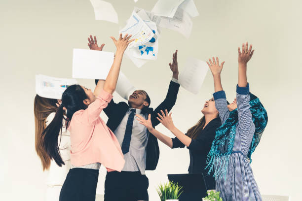 istock Business people throwing papers in the office. 1131295882