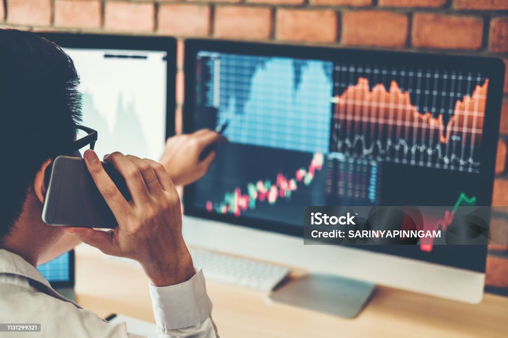 Investment stock market  Entrepreneur Business Man discussing and analysis graph stock market trading,stock chart concept Stock Market and Exchange Stock Photo