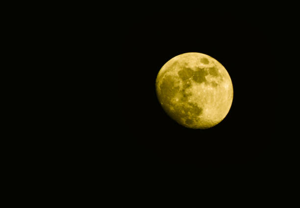 Super yellow moon isolated on black background - Real moon on dark night sky selective focus