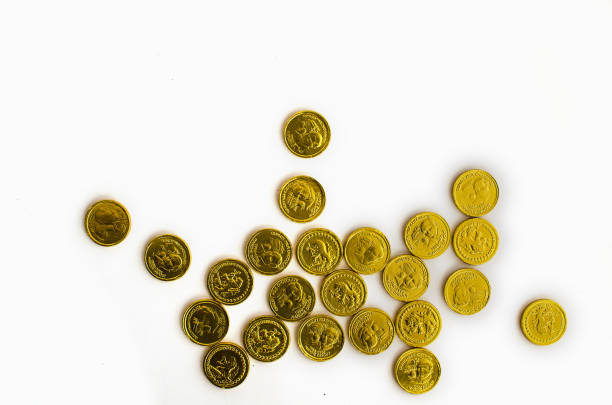 istock Bunch of chocolate gold coins on white background 1131305287