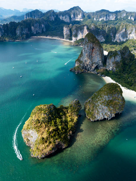 Aerial photo of Phra Nang and Railay beach, Krabi, Phuket, Thailand. Cliffs, rocks and jungles. Aerial view of green rocky cliffs and boats on Phra Nang beach bay, Railay beach, in Krabi Province, coastline in Phuket, Thailand. James Bond Island. phang nga bay stock pictures, royalty-free photos & images