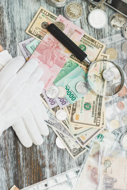 istock Hands in white gloves, different American dollars and Indonesian rupiahs, numismatics concept 1131310925