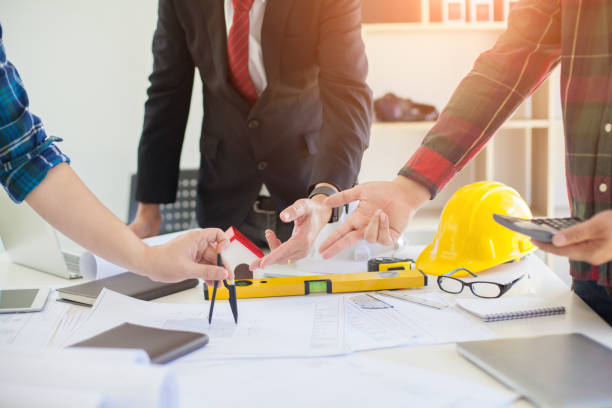istock Concept Agreement between the employer and architect Nick and desk of Architectural project in construction site or office building with mining light 1131312772