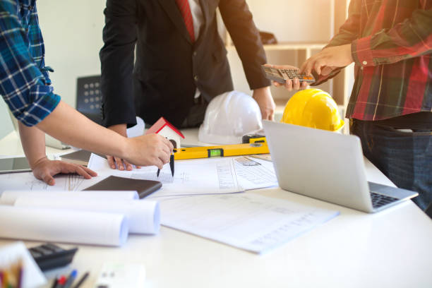 istock Concept Agreement between the employer and architect Nick and desk of Architectural project in construction site or office building with mining light 1131312827