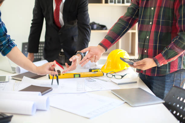 istock Concept Agreement between the employer and architect Nick and desk of Architectural project in construction site or office building with mining light 1131312853