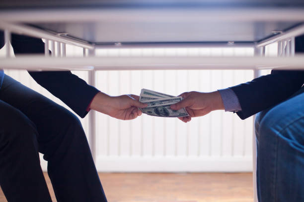 istock Bribery or corruption concept,pay money with office background 1131313524