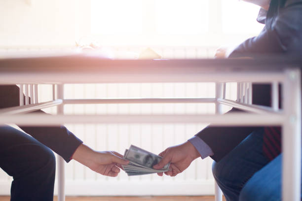 istock Bribery or corruption concept,pay money with office background 1131313542