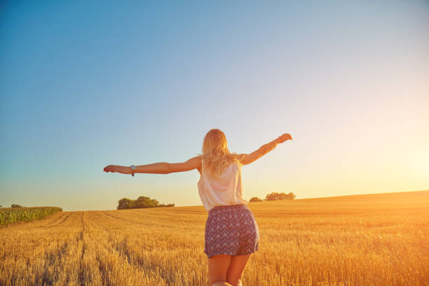 istock Cute young woman jumping in a wheat field. 1131317164