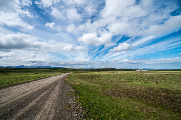 istock Empty dirt road through countryside landscape. 1131318360