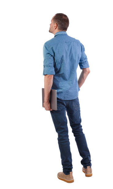 istock Back view of a man who is standing with a laptop. 1131318812