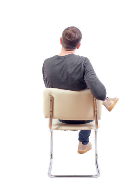 istock Back view of a man sitting on a chair. 1131319725