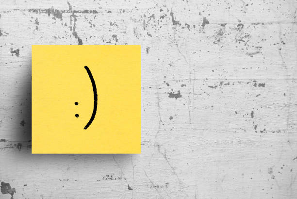 Sticky note on concrete wall, Smile Face Sticky note on concrete wall, Smile Face smiley face postit stock pictures, royalty-free photos & images