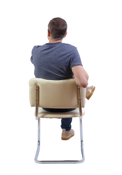 istock Back view of a man sitting on a chair. 1131319780