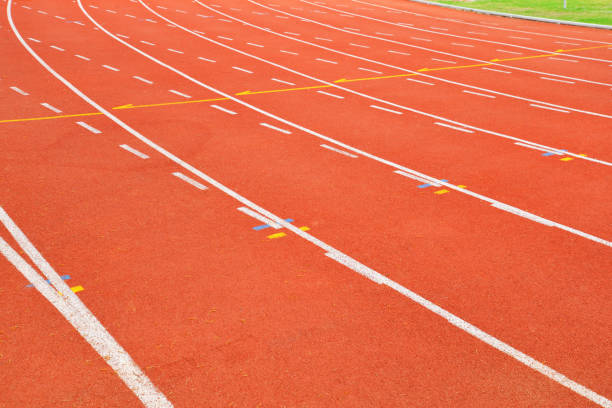 istock Athletics Track Run / Red running track in stadium with green field 1131319930