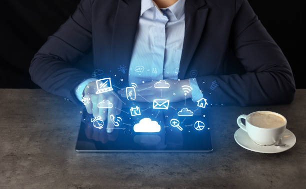 istock Business woman working on tablet with application symbols above 1131321356
