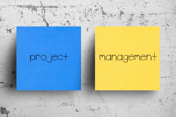 Photo of Sticky note on concrete wall, Project Management