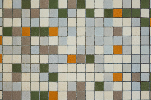 brownish mozaic tiles in a bathroom pattern with brown, white , yellow and green small tiles