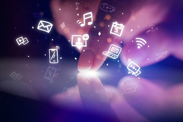 istock Finger touching tablet with hologram app icons above 1131325136