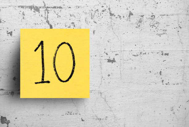 Sticky note on concrete wall, Number 10 Sticky note on concrete wall, Number 10 number 10 photos stock pictures, royalty-free photos & images