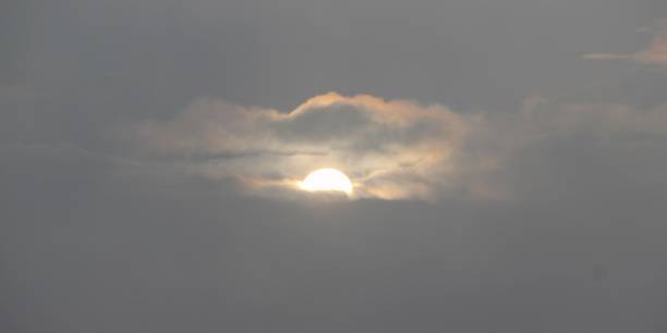 Armageddon on a hazy day, the sun could only be seen a little bit far in the clouds weltall stock pictures, royalty-free photos & images