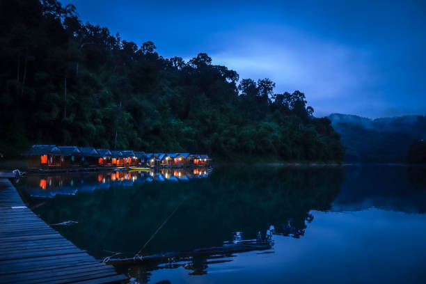 Floating village at night, Cheow Lan Lake, Khao Sok, Thailand Floating village at night in Cheow Lan Lake, Khao Sok, Thailand kao sok national park stock pictures, royalty-free photos & images