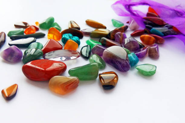 istock Assorted natural bright coloured semi precious gemstones and gems with a bag 1131327626