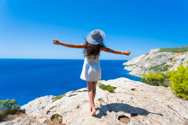 istock Happy woman standing arms outstretched on top 1131327983