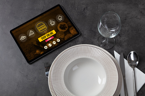 Online fast food order concept on a laid table