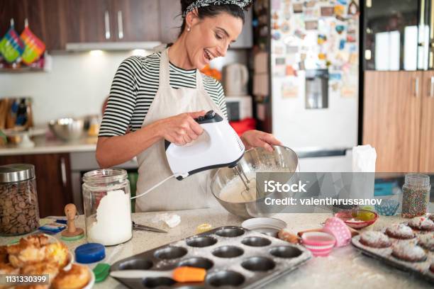 Confectioner Woman Making Delicious Cream For Cupcakes Stock Photo - Download Image Now