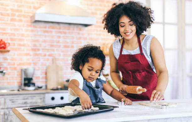 istock Mother and child molding dough together 1131330680