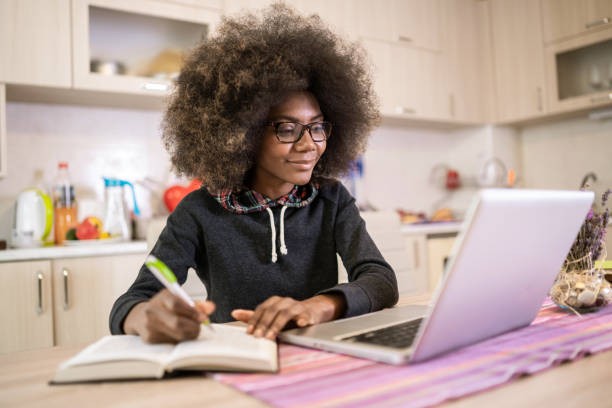 istock Young woman writing in front of her laptop 1131330749