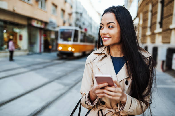 istock Millennial Vietnamese woman using phone while waiting for the public transport 1131330891