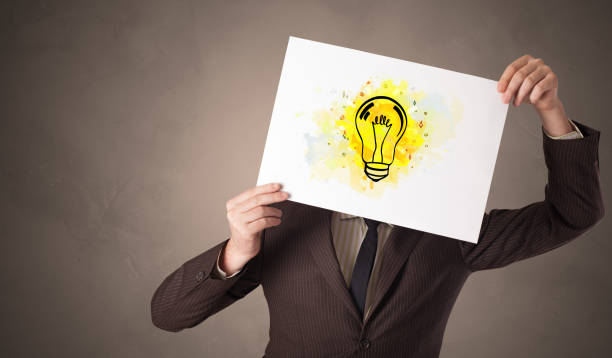 istock Person holding a paper with colorful bulb concept 1131330905
