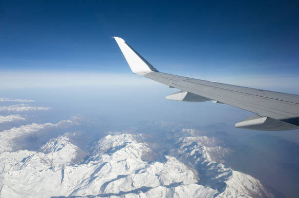 istock Jet Flying Over Snow Covered Mountains 1131331936
