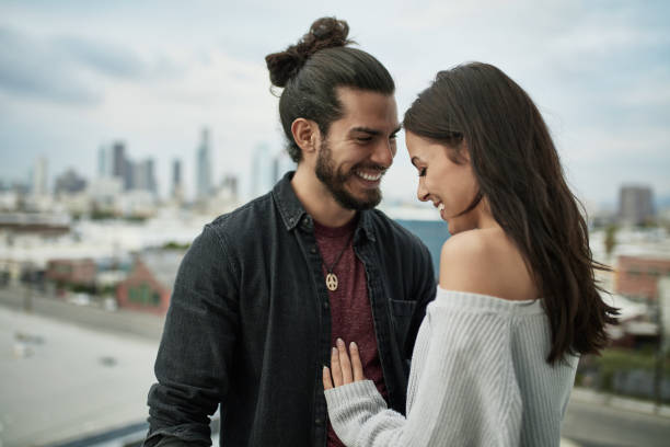 Smiling young couple spending leisure time in city