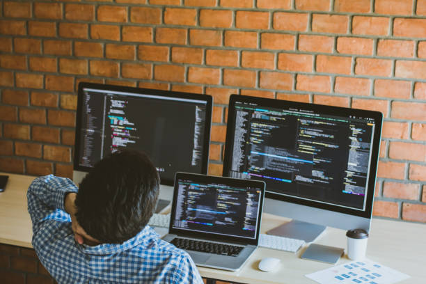 istock Business asian young man of professional computer Programmer is having, sitting at his working place with neck pain 1131334374